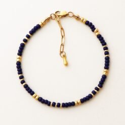 Close-up of the Cairo Navy Bracelet featuring navy Miyuki glass beads with gold accents and a gold clasp on a neutral background.