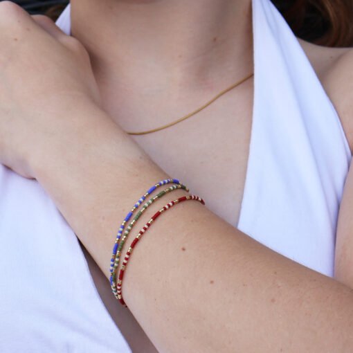 Three bracelets (red, green and blue with white and gold highlights) made with Miyuki glass seed beads.