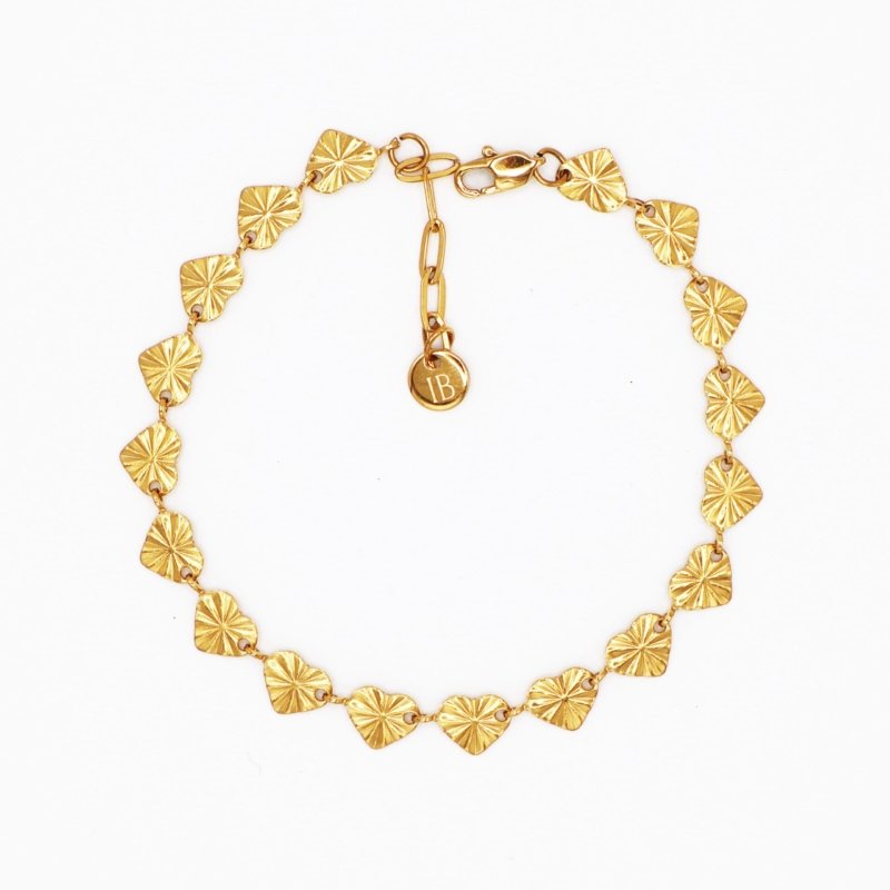 Gold fan-heart bracelet with charm tag, playful everyday statement piece