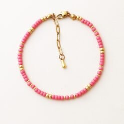 Close-up of the Cairo Pink Bracelet featuring soft pink Miyuki beads with gold accents and a gold clasp on a neutral background.